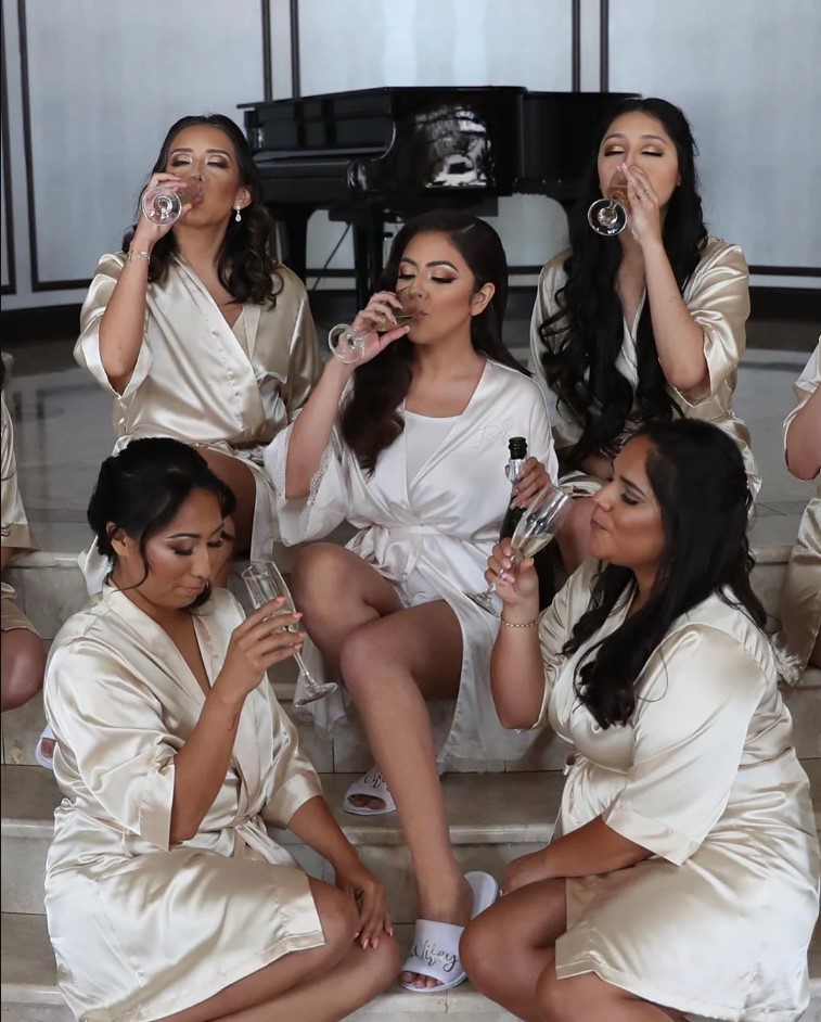 Beautiful bridesmaids in their champagne colored robes. Image Source: Theknot