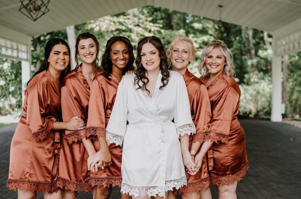 Bridesmaids in their burnt orange robes. Image Source: etsy.com
