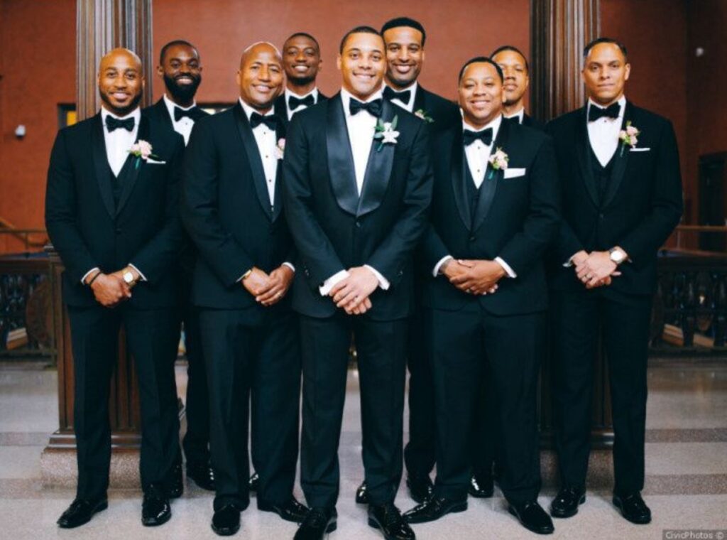 Groom (in the middle) with his groomsmen all rocking a black and white outfit. Image Source: CivicPhotos