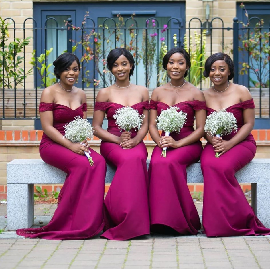 Beautiful bridesmaids in their burgundy-colored outfits.
