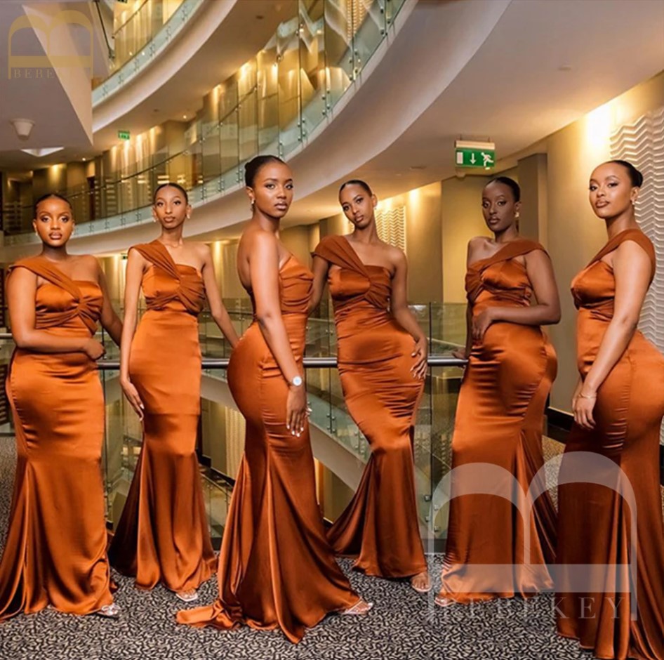 Gorgeous-looking bridesmaids in burnt orange outfits.
