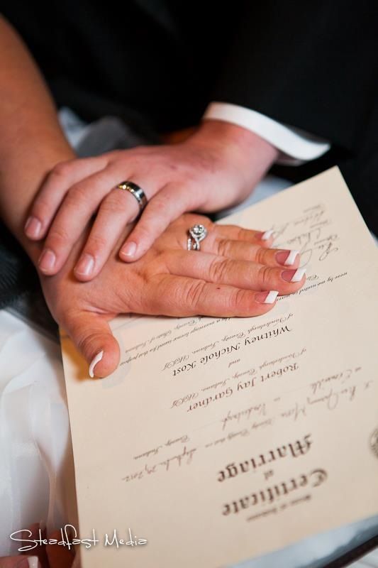 A couple signing their marriage certificate. Image Source: Steadfast Media