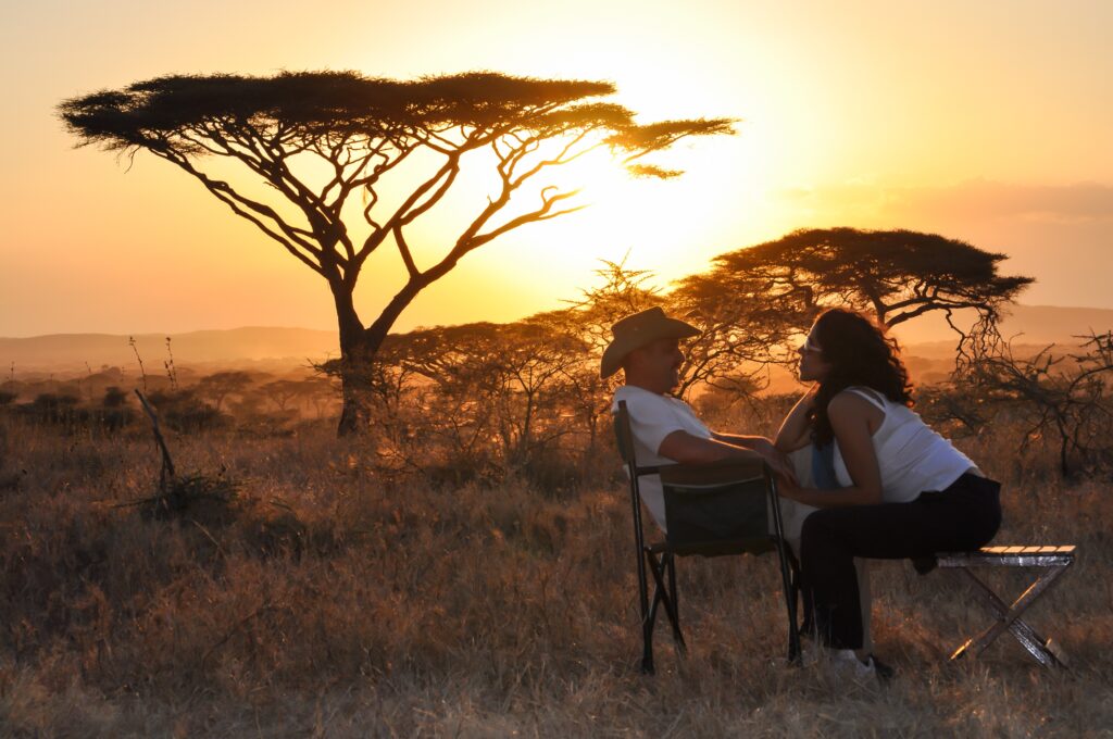 bridal couple sitting with sunset. Image Source: Istock