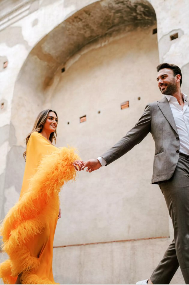 bride and groom holding hands looking at each other