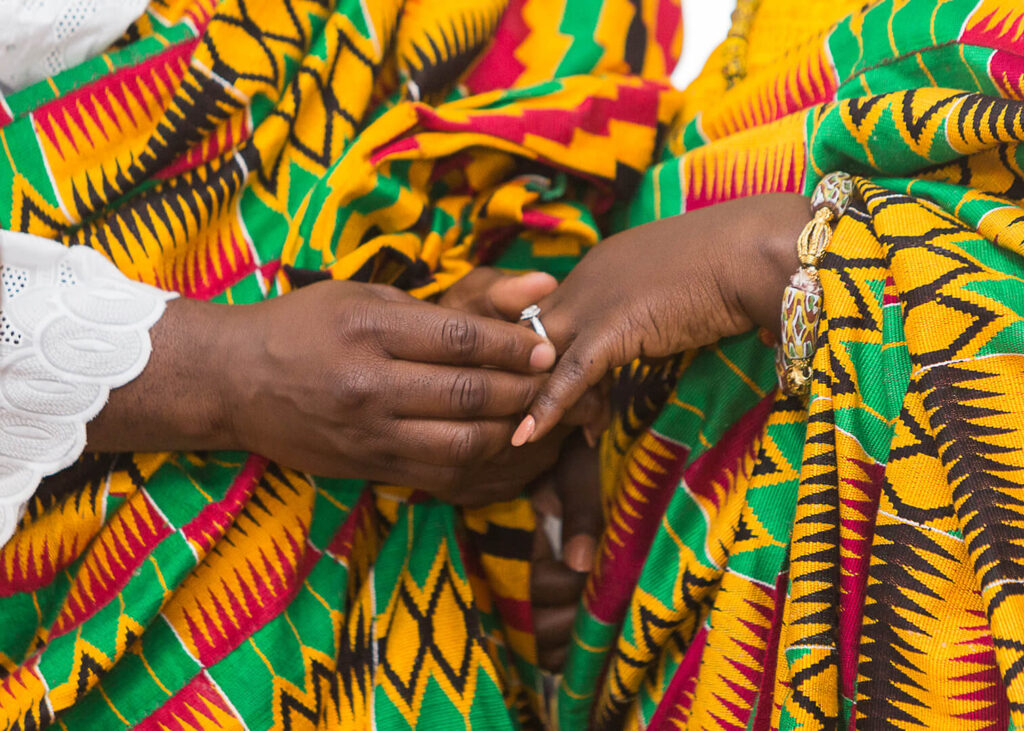 A Ghanaian couple in their colorful Kente fabrics on their traditional marriage. Image Source: thewvg