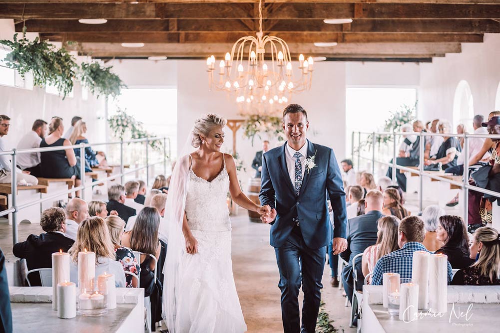 Couple having their outdoor wedding ceremony ar The Stone Cellar. Image Source: thestonecellar.co.za/gallery