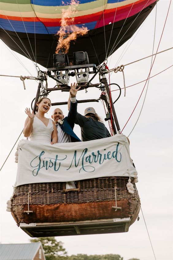 Custom hand-painted "Just Married" sign displayed on the hot air balloon! Source: whiteinkcalligraphy.com