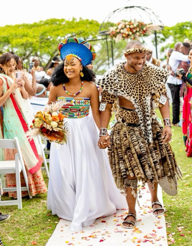 Modern Traditional Zulu Wedding in Durban, South Africa. Bride is in Ndebele beads, with isicholo. Groom is in leopard attire commonly known as ibheshu. Image Source: instagram.com