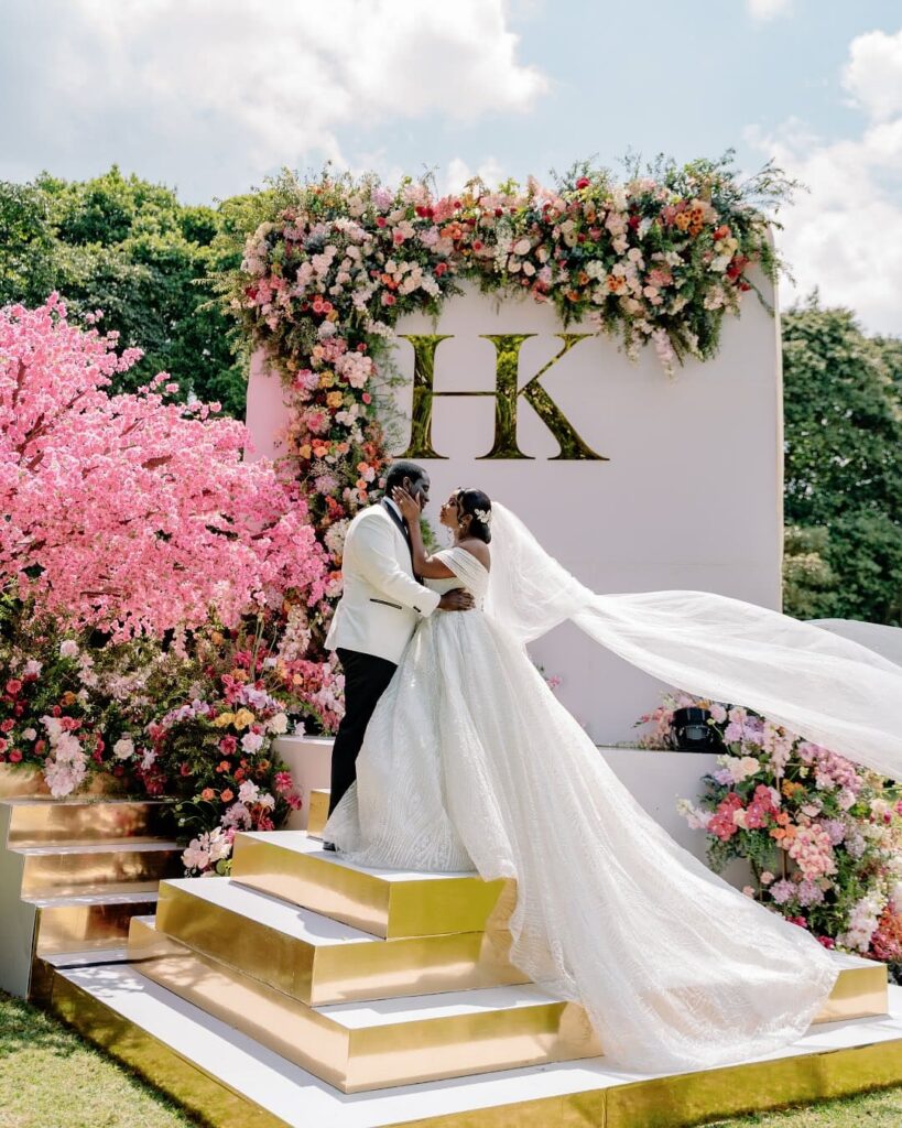 A garden transformed into a floral dream, layers of pinks, blushes, and tulips creating a world of romance for Hellen & Kevin. Image Source: Instagram/@auraeventplanners