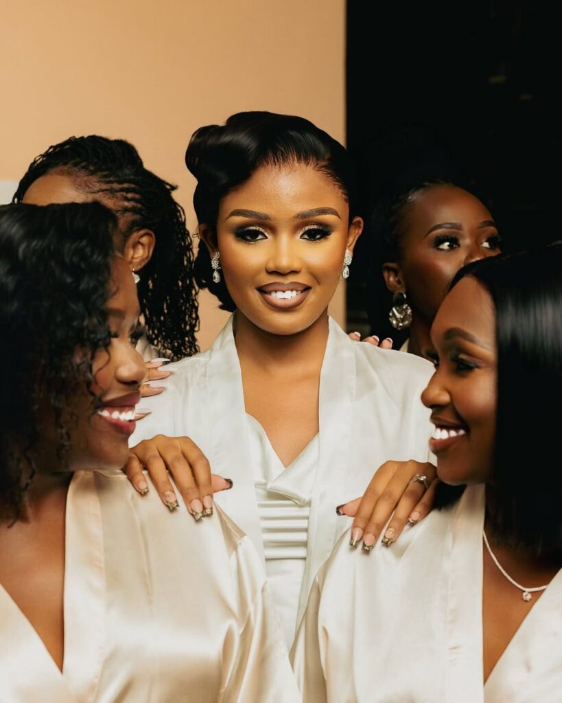 A beautiful Kenyan bride and her bridesmaids in their matching robes. Image Source: Instagram/@kapedophotography